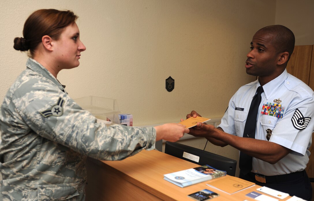 RAF ALCONBURY, United Kingdom - Tech. Sgt. Roger Kendall, 423rd Security Forces Squadron NCOIC of Police Services, assists an Airman in the operations section of the squadron Aug. 8. Kendall was recently named a 501st Combat Support Wing Everyday Hero from the 423rd Air Base Group. (U.S. Air Force photo by Senior Airman Joel Mease)