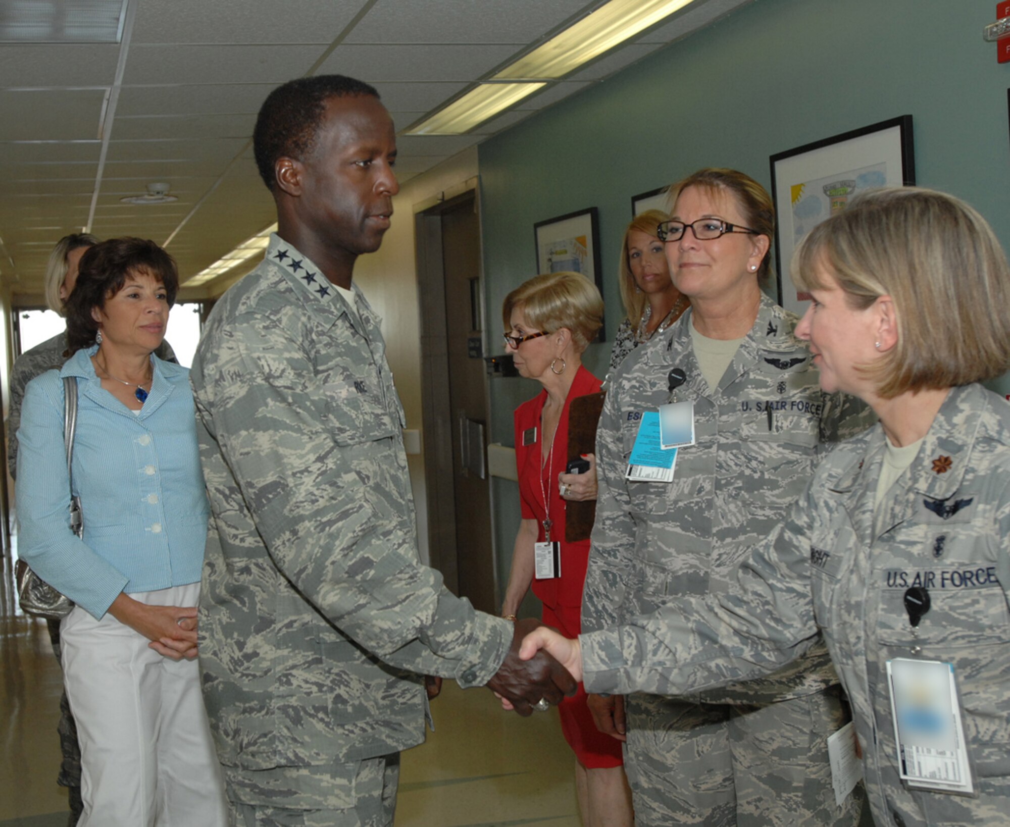 Air Education and Training Commander General Edward A. Rice Jr. greets Maj. Charlotte Knight (right) and Col. Debora Esque in the Contingency Aeromedical Staging Facility Aug. 3, 2011, at Wilford Hall Medical Center, Lackland Air Force Base, Texas. Rice and his wife, Mrs. Teresa Rice (left), toured the new facility, which opened June 13, 2011, during their visit to Wilford Hall and other 59th Medical Wing facilities. Knight is the 59th CASF flight commander and Esque is the 59th CASF commander. (U.S. Air Force photo by Staff Sgt. Robert Barnett)