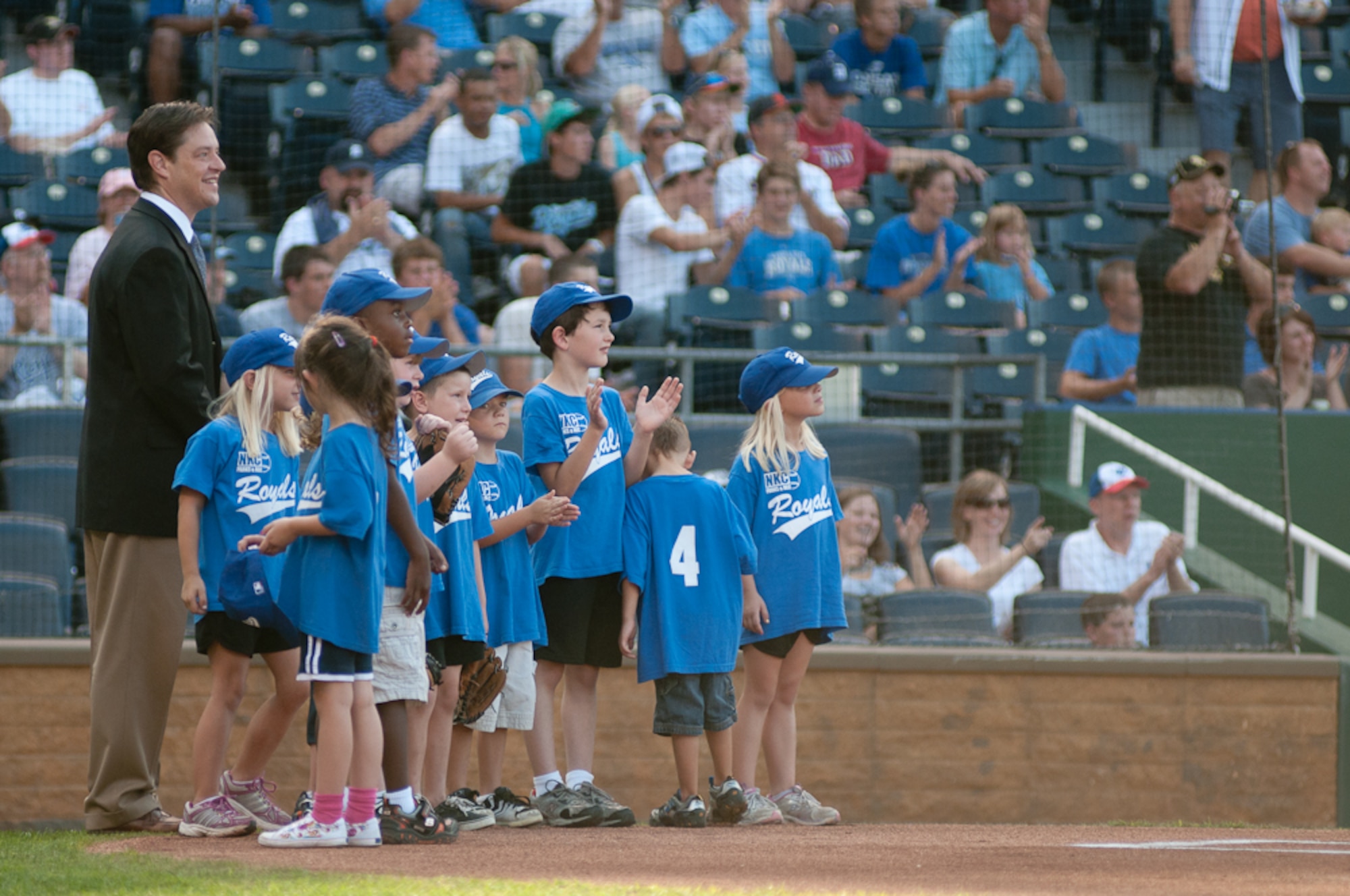 Son of 139th Airlift Wing Member Staff. Sgt. Rachel Montesano, Dominic, speaks with a member of Royals staff, after seeing his deployed mother on the Jumbo Tron at The Kansas City Royals baseball game on Aug. 6, 2011 in Kansas City Mo. The Royals hosted Armed Forces Day to honor all veterans of the military. (U.S. Air Force photo by Senior Airman Sheldon Thompson)