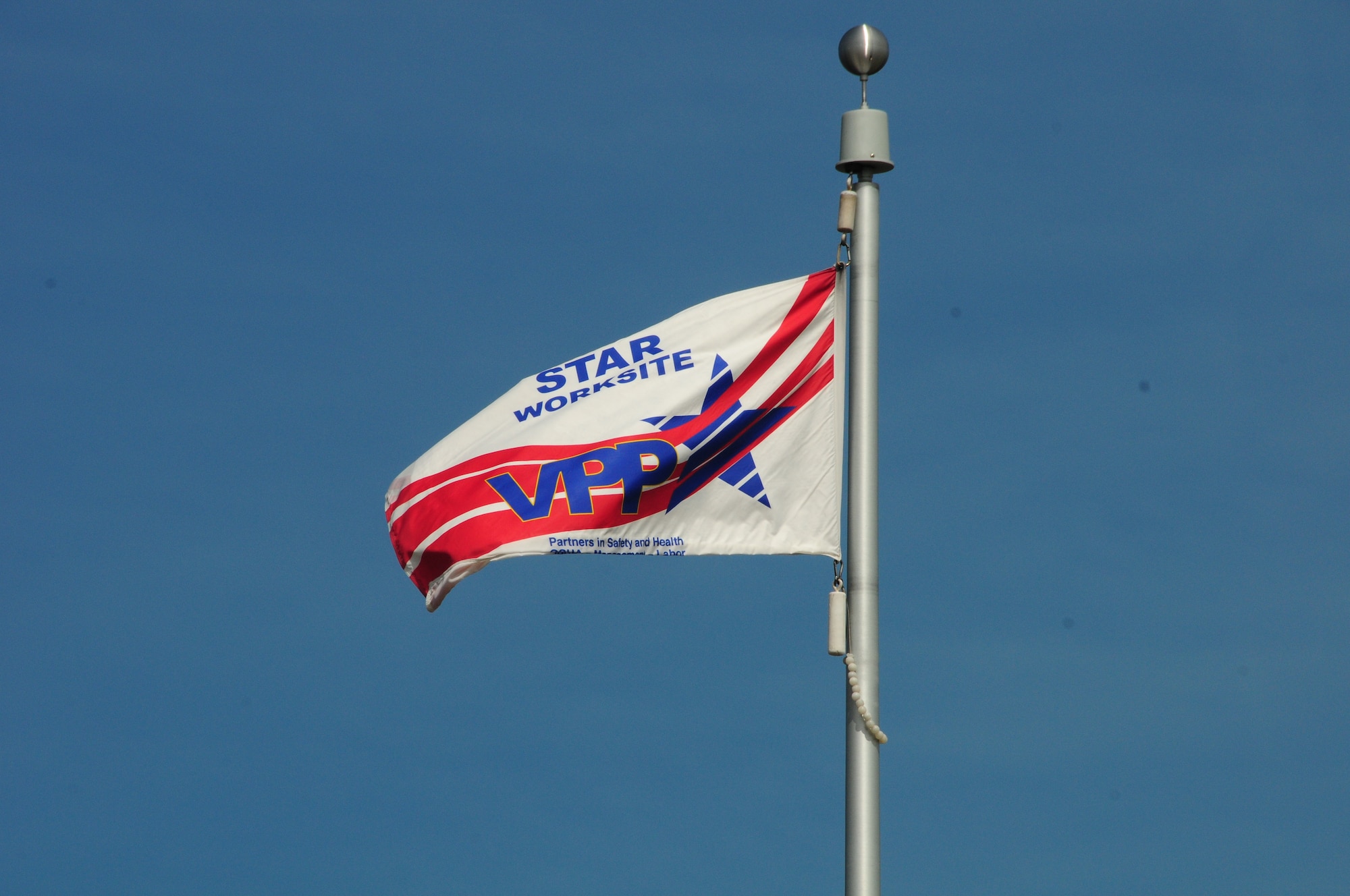 The Voluntary Protection Program flag flies proudly at the 148th Fighter Wing.  The 148th Fighter Wing has just been recertified as part of the VPP as a Star worksite—the Star status is OSHA’s highest rating. (U.S. Air Force photo by Master Sgt. Ralph Kapustka/released) 
