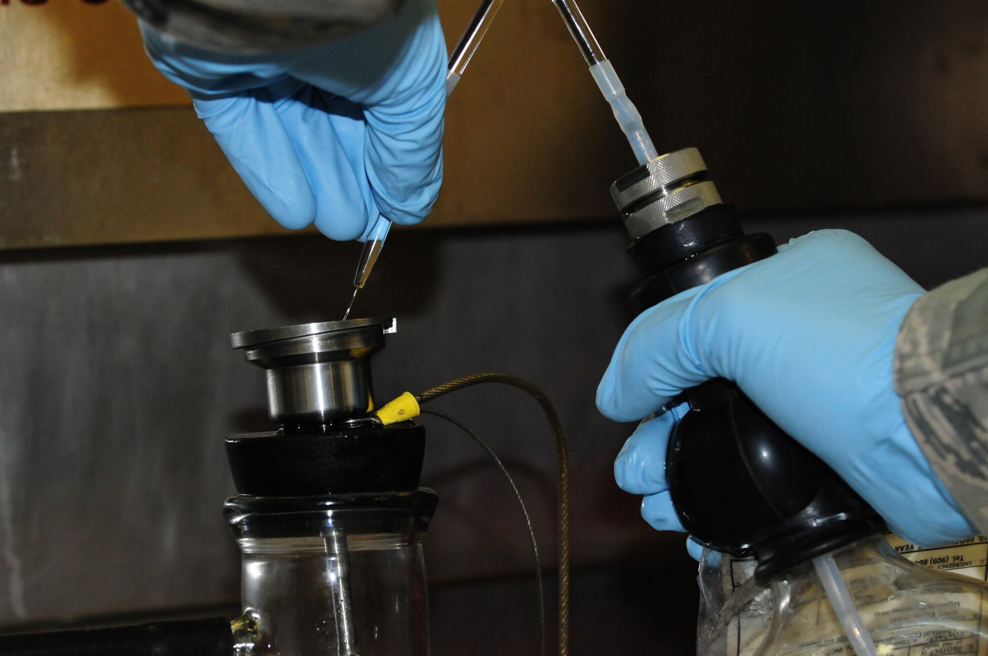 SPANGDAHLEM AIR BASE, Germany – A 52nd Logistics Readiness Squadron fuels lab Airman performs a bottle-method test to determine the solids content of the fuel here Aug. 9. The LRS fuels maintenance flight provides clean, dry fuels and cryogenic products for the 52nd Fighter Wing. (U.S. Air Force photo/Airman 1st Class Matthew B. Fredericks)