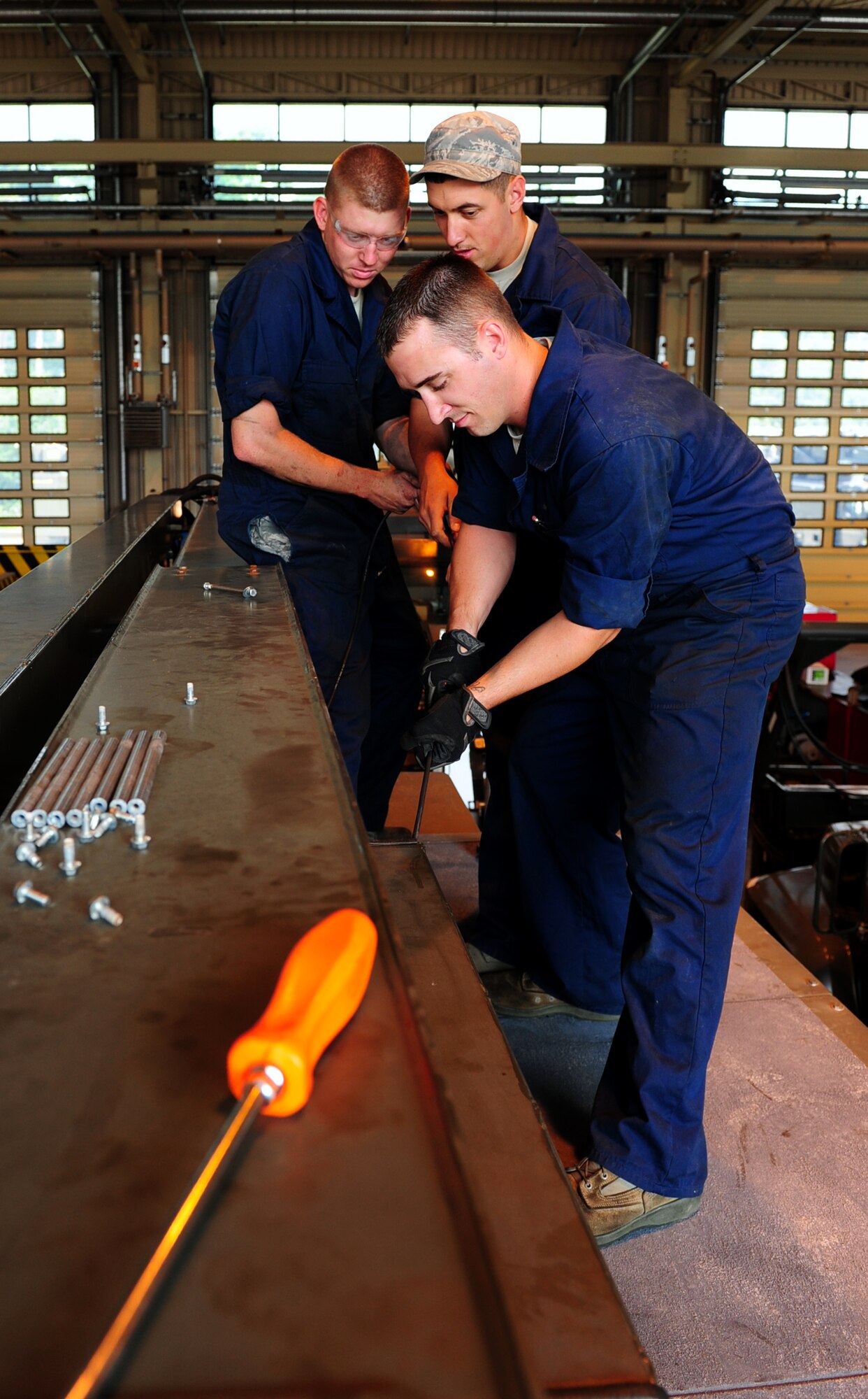U.S. Air Force vehicle maintainers from the 86th Vehicle Readiness Squadron special purpose snow team replace a communications cable on an aircraft de-icer during the shop's summer rebuild operations, Ramstein Air Base, Germany, Aug. 4, 2011. The 14-man team has five months to repair 35 vehicles before the winter; vehicles including aircraft de-icers, snow brooms, snow plows and salt spreaders. (U.S. Air Force Photo by Airman 1st Class Brea Miller)