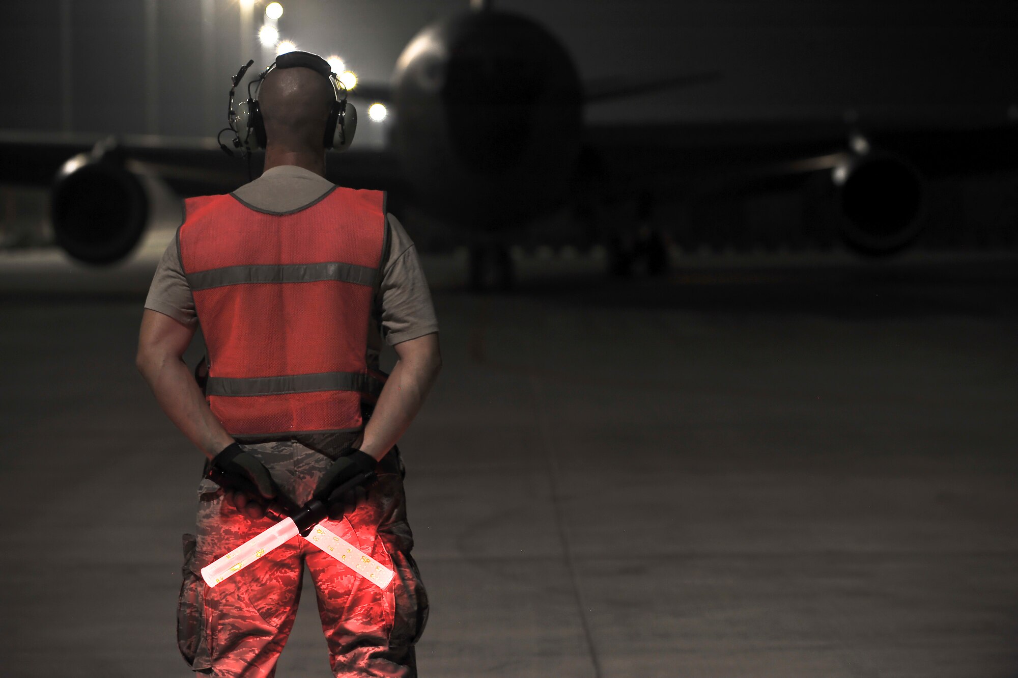 Staff Sgt. Justin Dahlmann, 340th Expeditionary Aircraft Maintenance Unit, waits to marshal out a KC-135 Stratotanker, July 31, 2011. The aircraft flew the 1,000th tanker sortie in the month of July breaking the previous monthly record by 104 sorties.
(U.S. Air Force photo/Senior Airman Paul Labbe)