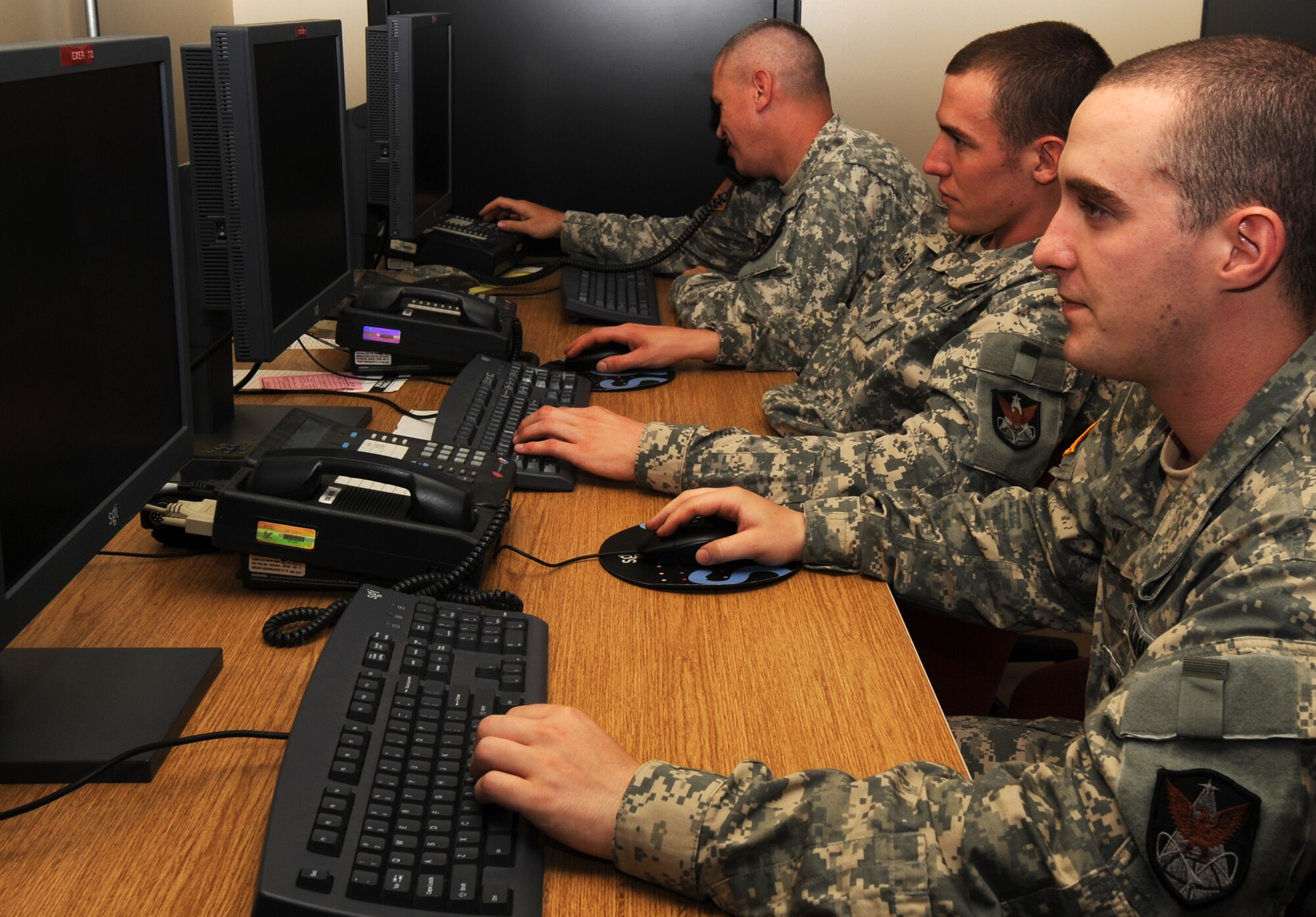 MISAWA AIR BASE, Japan -- U.S. Army Staff Sergeant Larry Morrison, front, U.S. Army Sergeant Michael Hollenbaugh, and U.S. Army Specialist Bryan King, rear, Joint Tactical Ground Station Delta Detachment, 1st Space Company, conduct proficiency training to maintain their system expertise Aug. 2.  Training is held weekly to keep the soldiers prepared for combat.  (U.S. Air Force photo/Staff Sgt. April Quintanilla)