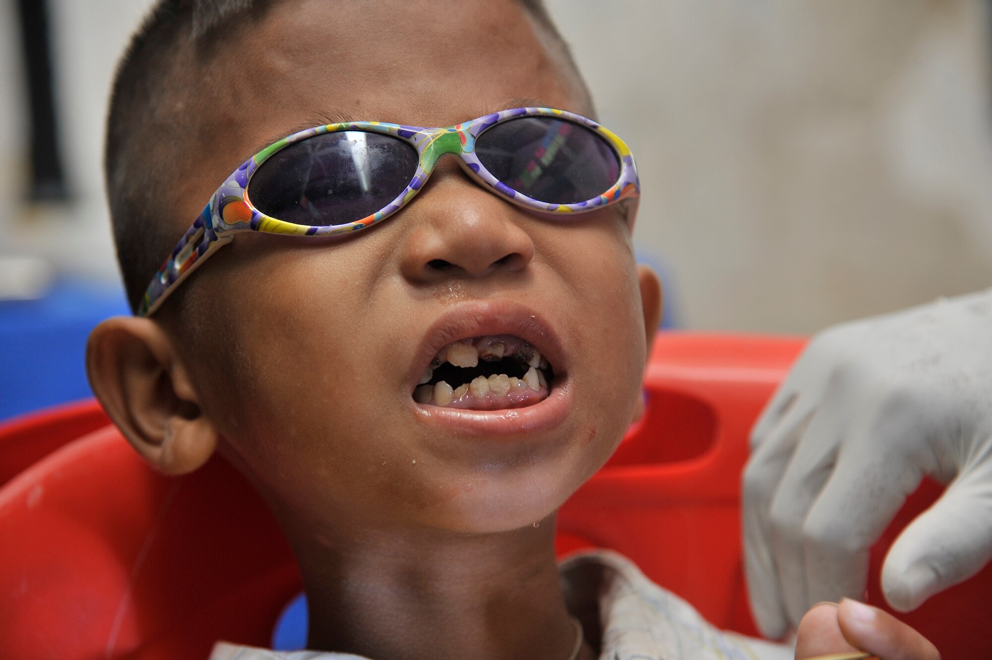 BAK KLARNG, Cambodia -- A young Cambodian boy awaits dental care from U.S. and Royal Cambodian Armed Forces during Operation PACIFIC ANGEL 11-1 Aug. 8, 2011, Bak Klarng, Cambodia. PA 11-1 partners U.S. and Cambodian military and civilian personnel to provide medical, dental, optometry and engineer programs to local Cambodians as well as airfield operations and infection control subject-matter expert exchanges. (U.S. Air Force photo/Staff Sgt. Christopher Boitz)