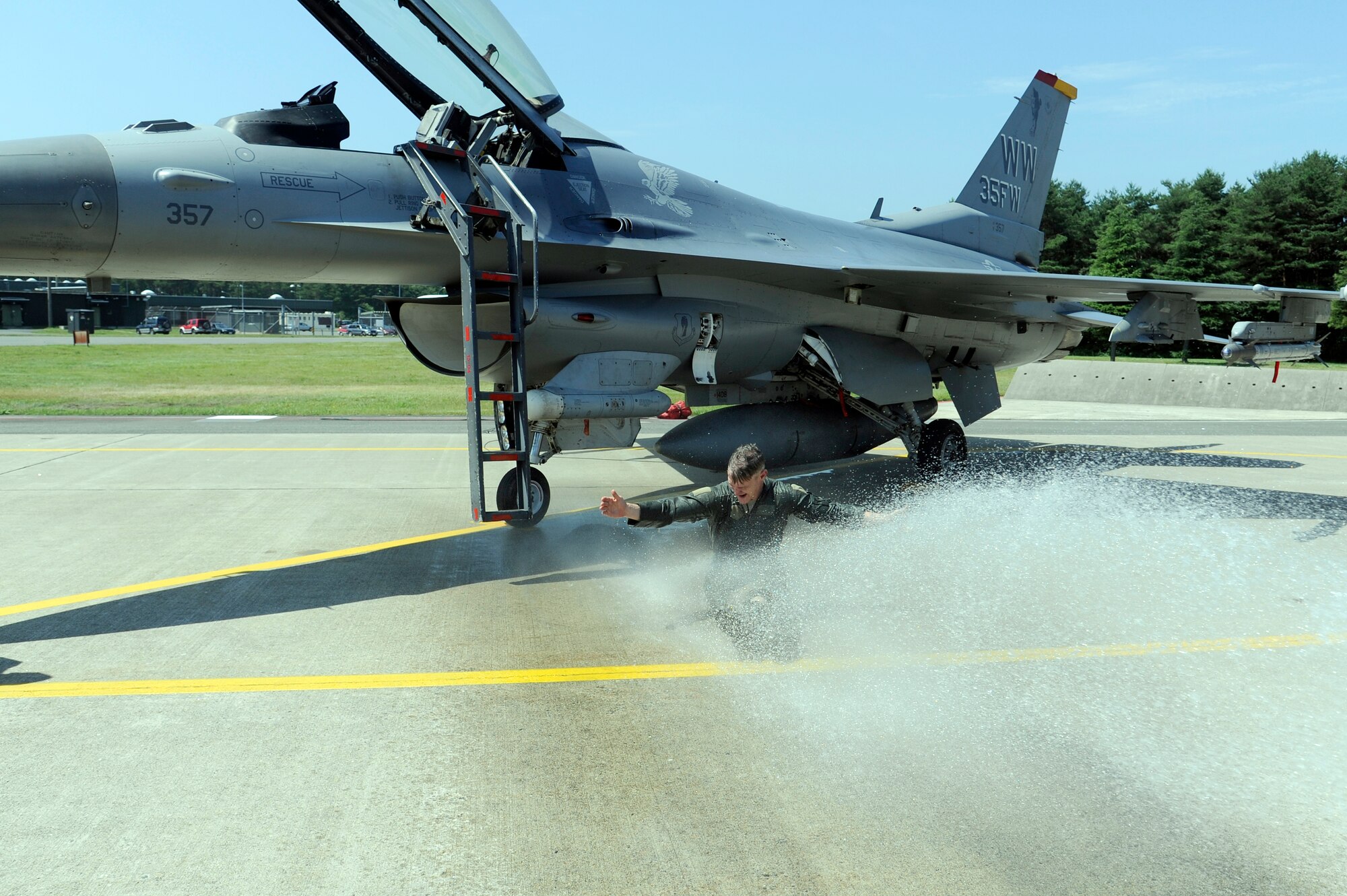 MISAWA AIR BASE, Japan -- Col. John Pearse, 35th Operations Group commander, is hosed down on the flightline after completing his "fini-flight" in an F-16 Fighting Falcon Aug. 5. It is tradition to hose down the pilot with water or other beverage in celebration of their final flight with a unit. (U.S. Air Force photo/Tech. Sgt. Marie Brown/Released)
