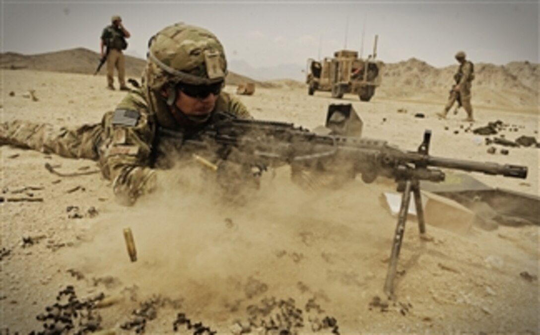 U.S. Air Force Master Sgt. Jeffery Needham, a staff platoon sergeant attached to the Laghman, fires his Mk 48 machine gun at wooden targets while practicing at the off-base firing range near Forward Operating Base Mehtar Lam in Laghman province, Afghanistan, on Aug. 6, 2011.  Members of the Provincial Reconstruction Team and the Security Forces Assistance Team traveled to the range to practice with primary and secondary weapons and M203 grenade launchers.  