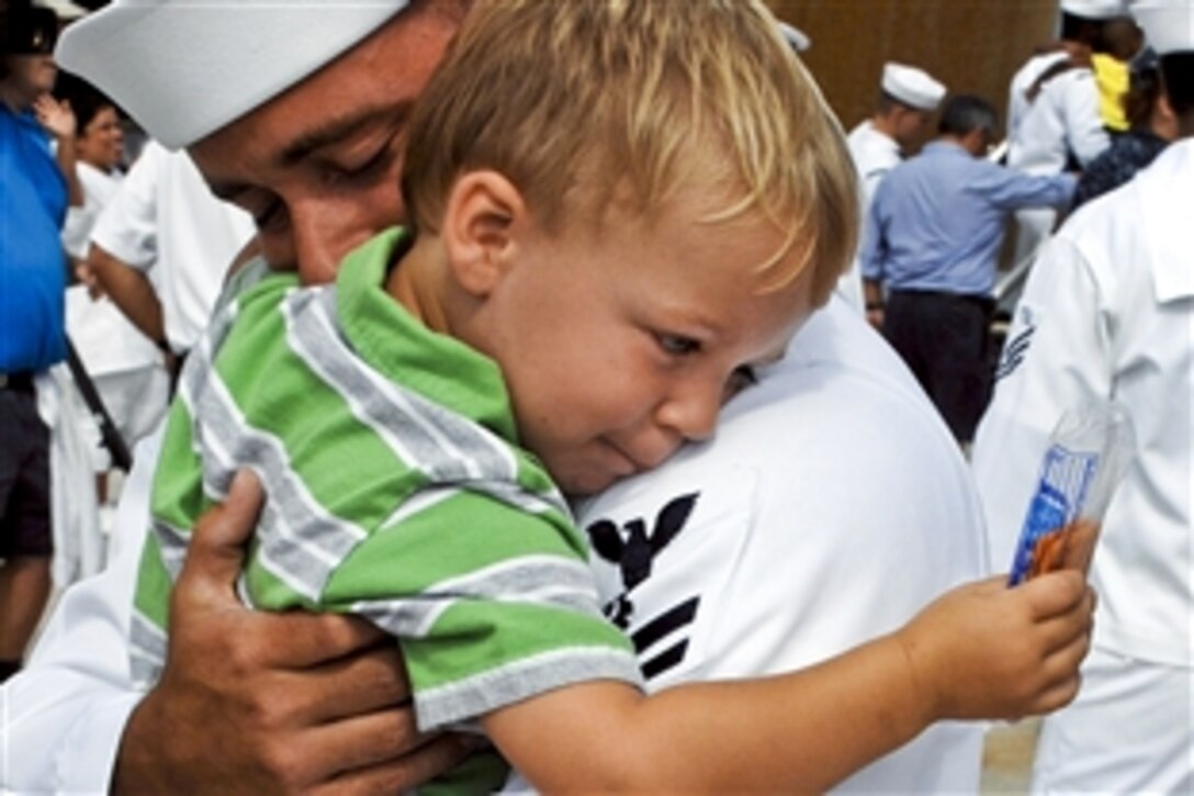 U.S. Navy Petty Officer 2nd Class Tommy Neely holds his son after returning home from a seven-month deployment aboard the guided-missile destroyer USS Bainbridge in Norfolk, Va., Aug. 5, 2011. The Bainbridge was deployed to the U.S. 5th and 6th Fleet areas of responsibility.