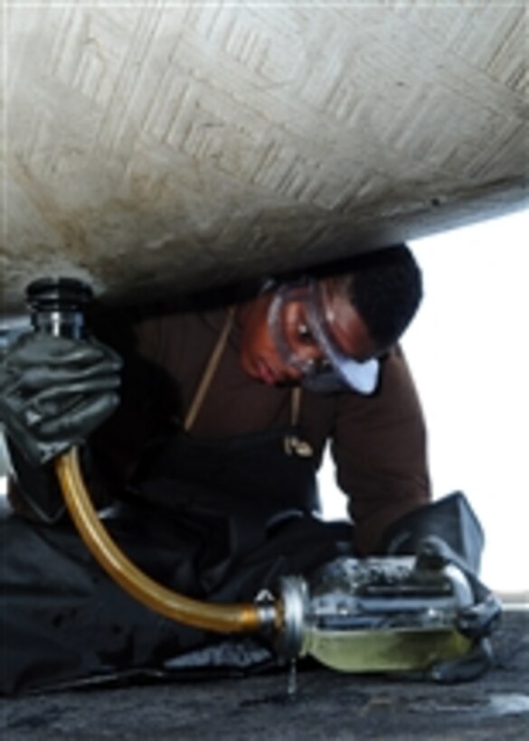 Airman Raven King takes fuel samples from an F/A-18 Hornet aboard the aircraft carrier USS Ronald Reagan (CVN 76) in the Arabian Sea on Aug. 1, 2011.  The Ronald Reagan is conducting operations supporting maritime security operations and theater security cooperation efforts in the U.S. 5th Fleet area of responsibility.   