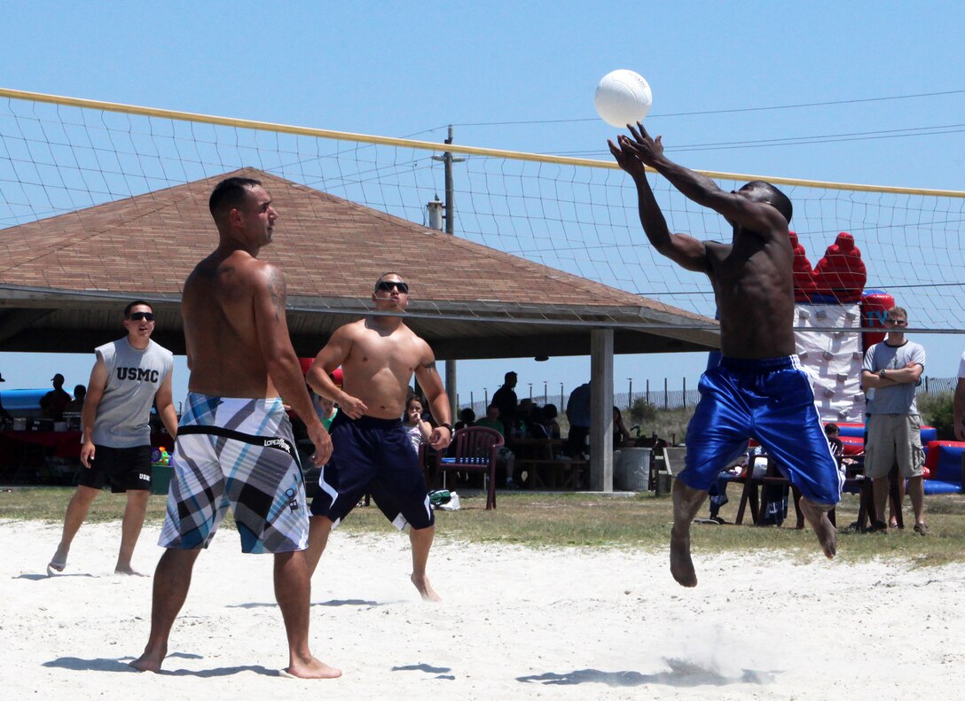 Marines and Sailors with the 24th Marine Expeditionary Unit participate in a volleyball game at Camp Lejeune’s Onslow Beach, Aug. 9. The 24th Marine Expeditionary Unit Marines, Sailors and their families took a day off work to relax on the beach and build unit cohesion.