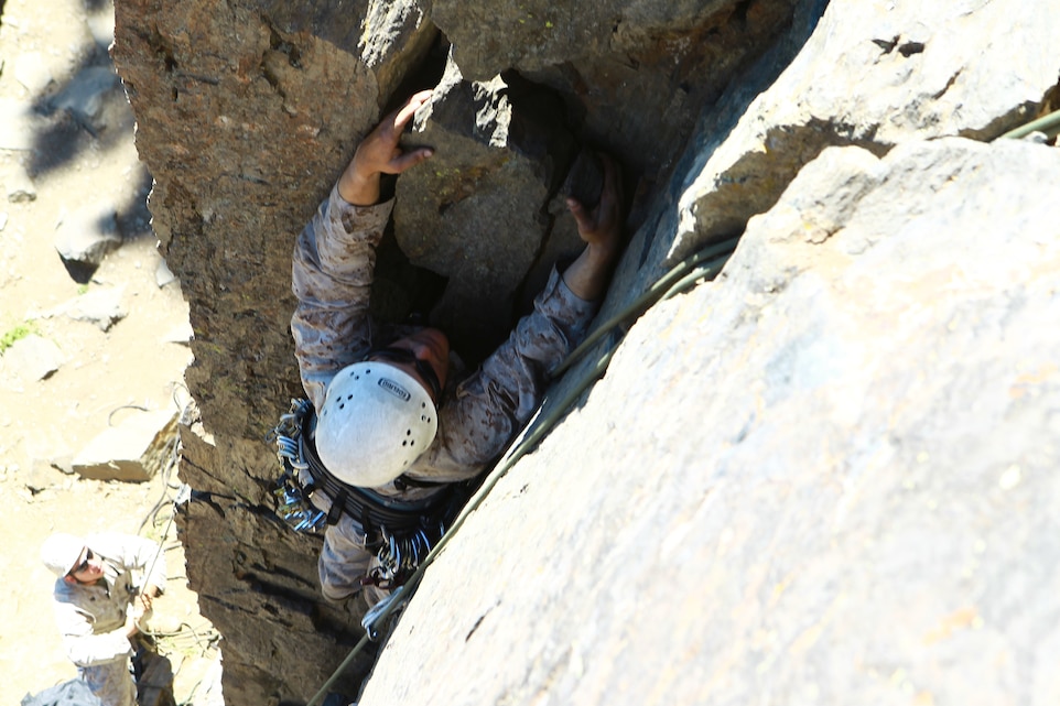 2nd Lt. Jordan Alley, a platoon commander with Company C, 1st Battalion, 4th Marine Regiment, hangs onto the rock face near the end of his 40-foot-tall top-roping exercise during the Mountain Leaders Course at the Marine Corps Mountain Warfare Training Center in Bridgeport, Calif., Aug. 10, 2011.
