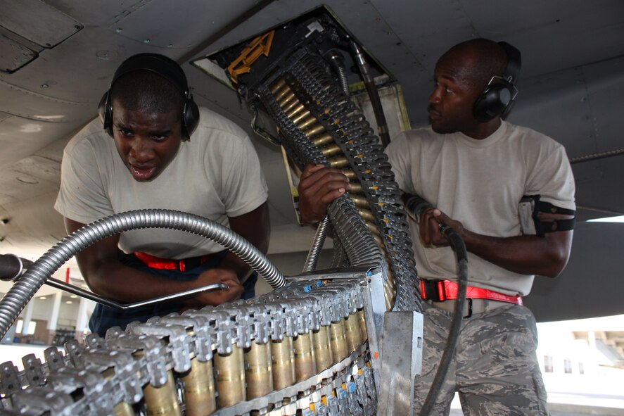 Staff Sgt. Marcus Wilson (right) and Airman Manuel Wyley (left) of the 67th Aircraft
Maintenance Unit load rounds into an F-15 during a Local Operational
Readiness Exercise on Kadena Air Base, Japan, Aug. 10.  During the exercise,
Kadena Airmen applied learned skills used during normal and contingency
operations. (U.S. Air Force photo/Maj. John Jacobus)