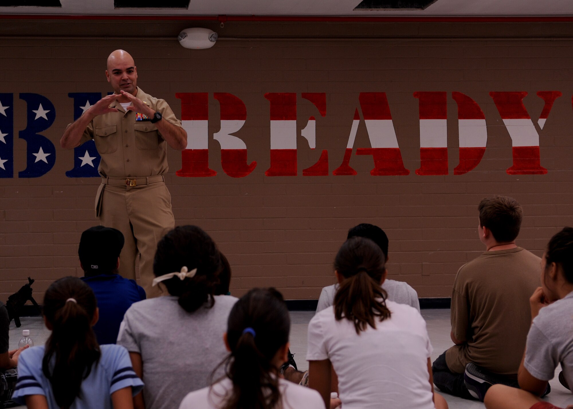 DAVIS-MONTHAN AIR FORCE BASE, Ariz. – Chief Petty Officer Terrance White, Navy Operational Support Center Tucson, speaks with local Tucson community children during Operation Military Kids here Aug. 4. Approximately 29 children from families of different military backgrounds attended this event. (U.S. Air Force photo/Airman 1st Class Christine Halan)