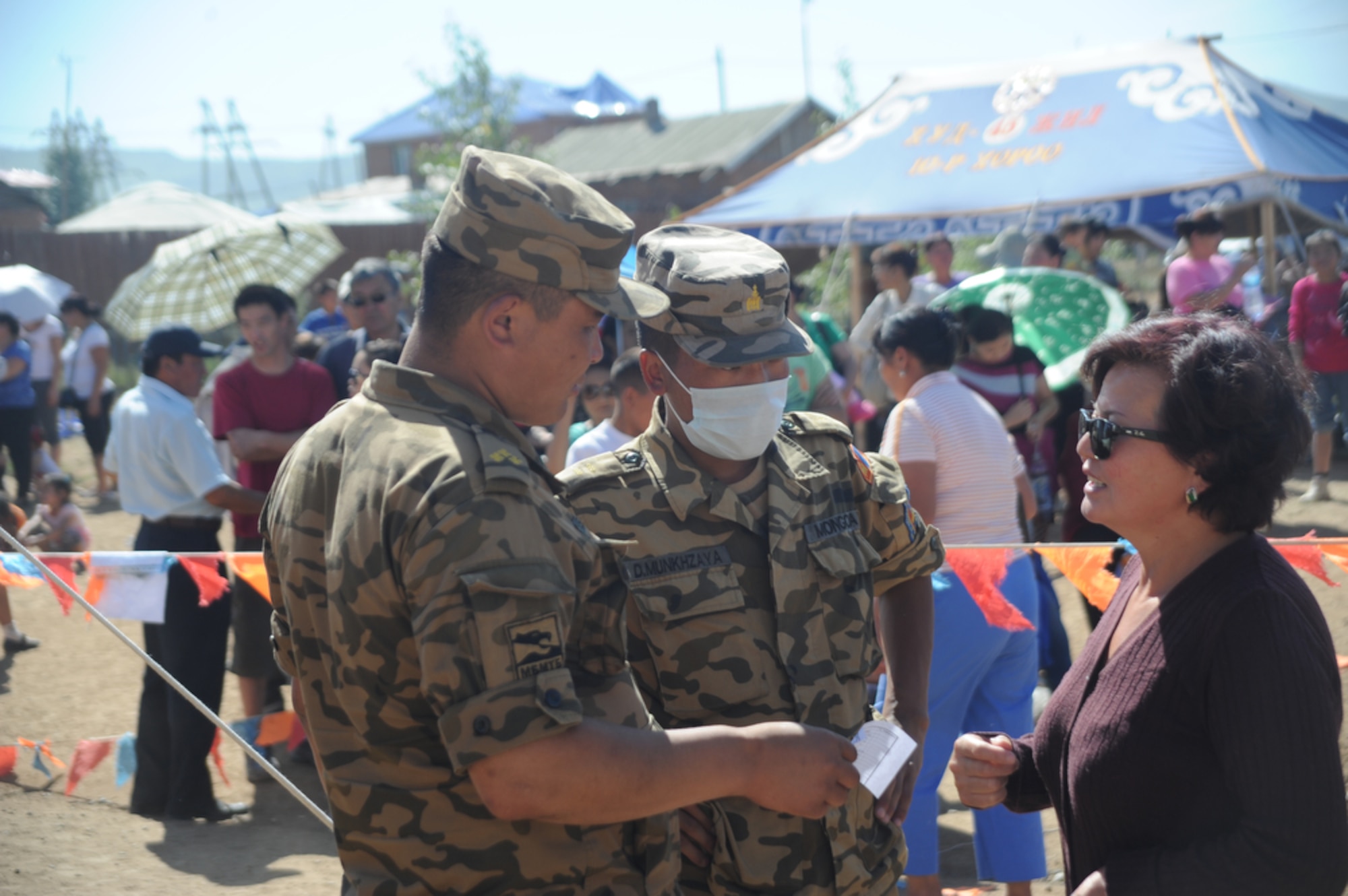 ULAANBAATAR, Mongolia - A Mongolian woman asks two soldiers with the Mongolian Armed Forces for directions to the surgical section of the mini clinic at the Buynt Uhaa Complex in Ulaanbaatar, Mongolia on Aug. 9 during Khaan Quest 2011, a combined joint-exercise hosted by the Mongolian Armed Forces in partnership with U.S. Pacific Command forces. Medical Civil Action Programs like this enable the countries involved to become familiar with one another in addition to helping the community of the host country.  Khaan Quest officially started July 31 and continues until Aug 12. (U.S.  Air Force photo/Master Sgt. Cohen A. Young)
