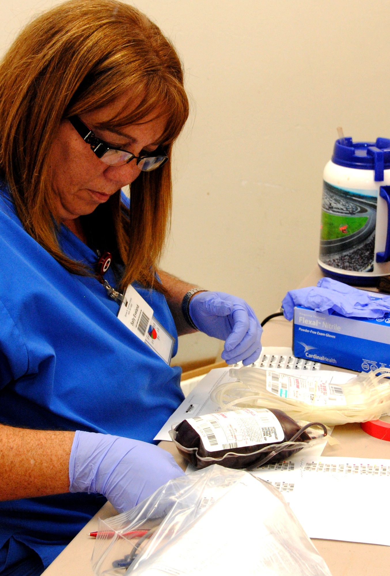 Sally Eveland, a supervising phlebotomist with the Oklahoma Blood Institute, prepares a donation taken from one of more than 100 Team Vance members who participated in the blood drive July 29 at Vance AFB, Okla. (U.S. Air Force photo/ Jessica Gibson)