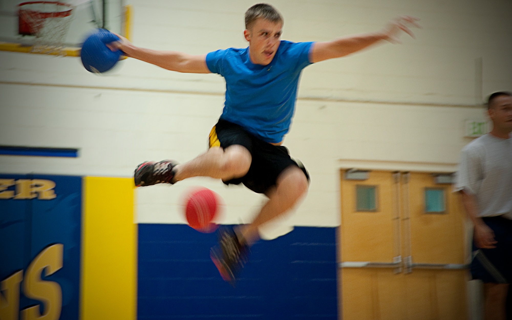 Senior Airman Travis Sandlin, 403rd Maintenance Squadron, locks in on his target as he hurdles over an assailant's dodge ball during the 403rd Wing's dodge ball tournament Aug. 6 at the Blake Fitness Center. The event was held as part of the Human Resource Development Council's quarterly fitness challenge.  The 403rd Operations Group defeated the 403rd Logistics Squadron in the finals. (U.S. Air Force photo by Staff Sgt. Brent Skeen)