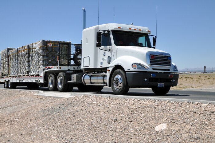 A Federal Emergency Management Agency tractor-trailer from the Nevada Urban Search and Rescue Task Force One carries cargo pallets of response equipment and supplies July 20, 2011, near the flightline at Nellis Air Force Base, Nev.  FEMA and the Air Force jointly conducted an exercise to simulate recalling the Nevada Task Force for a disaster or emergency and preparing FEMA personnel and equipment to fly aboard a military aircraft. (U.S. Air Force photo by 2nd Lt. Ken Lustig/Released)
