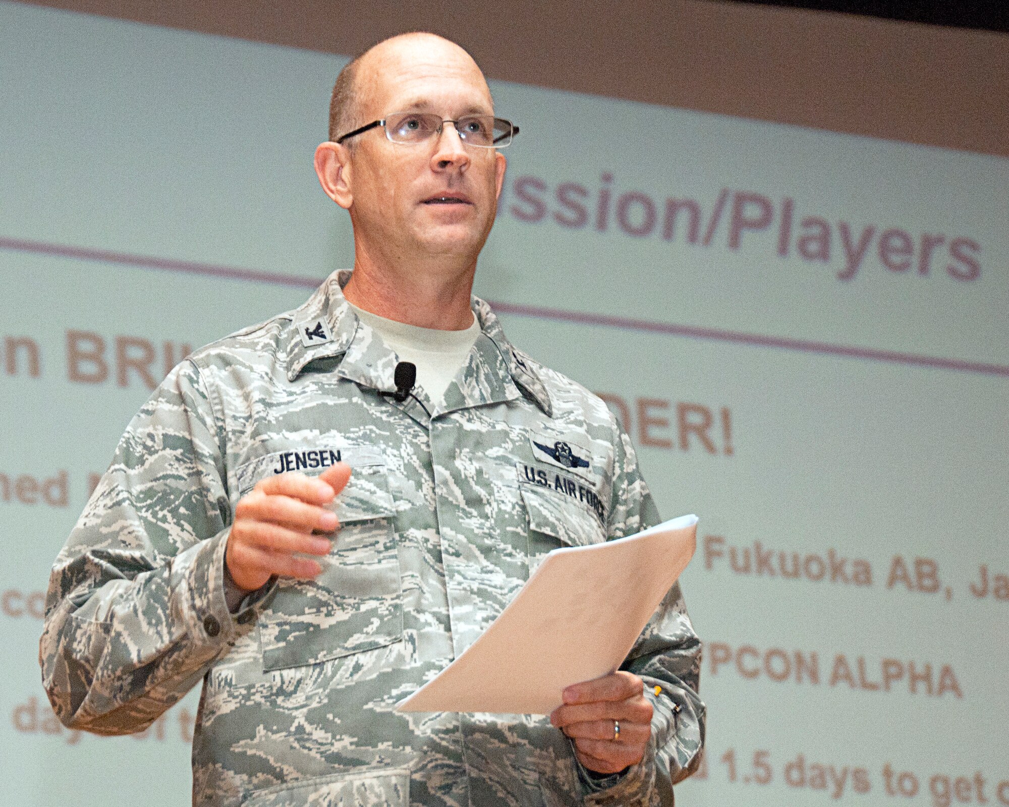Colonel Jay Jensen, 403rd Wing commander, briefs his airmen on the Readiness Assessment Visit II results during his commander's call Aug. 6. He congratulated and thanked the Wing for their "superior" attitude during the exercise. Jensen emphasized how having the right attitude is the main ingredient for success in the upcoming Operational Readiness Exercise in October.