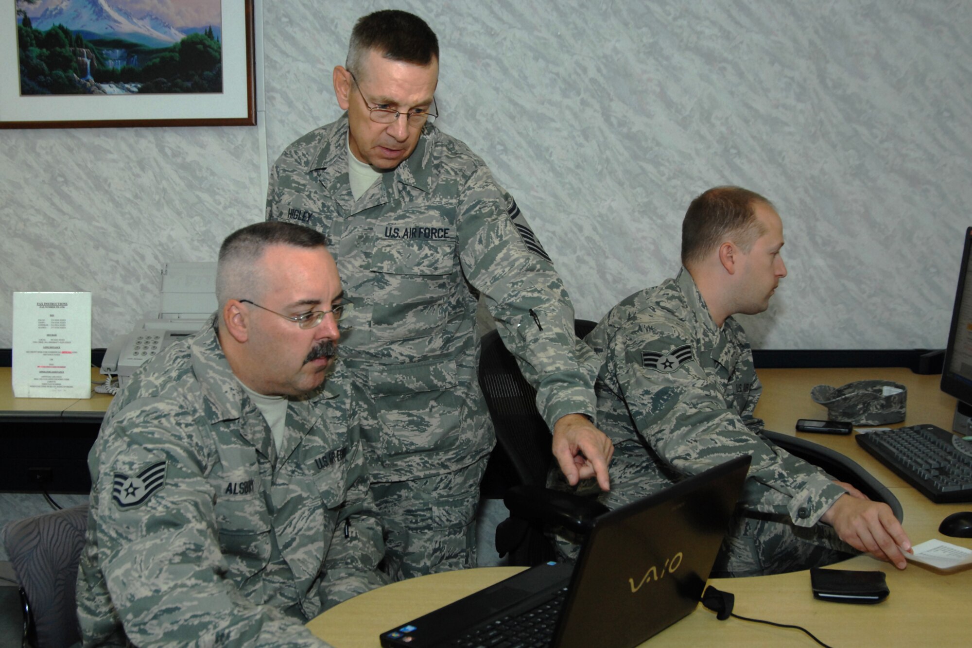 Staff Sgt. Jeffrey Alsbury, Senior Master Sgt. Denver Higley, and Senior Amn. Donald Russell,  logistic planners for the 127th Logistics Readiness Squadron, work on deployable work stations, creating an impromptu logistics office inside the lobby of the North Star Inn, at Elmendorf Air Base, Alaska.  They are seen here preparing the X-Man list of 127th LRS personnel which will be used to create a passenger manifest upon redeployment back to Selfridge, ANGB, Mich., where the 127th is based as part of the Michigan Air National Guard. In late July and early August, approximately 40 Airmen from the 127th LRS spent their two weeks of annual training integrated with the active duty and guard personnel of Joint Base Elmendorf/Ft. Richardson, where they accomplished core task training, and shared knowledge and skills with their counterparts.  (USAF Photo by SSgt. Rachel Barton)