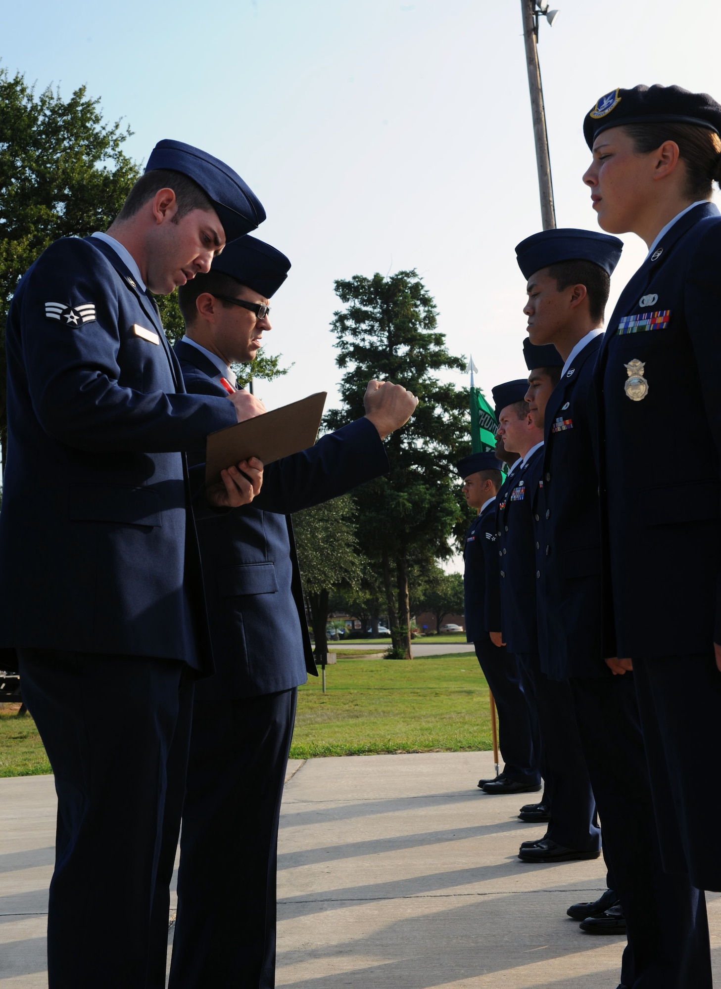 U.S. Air Force Staff Sgt. Shane Harvey, 20th Force Support Squadron Airman Leadership School instructor, points out discrepancies during the Airmen?s first ALS service dress inspection at Shaw Air Force Base, S.C. July 10, 2011. ALS is a five-week long designed to turn airmen into supervisors and focuses on leadership and leadership duties. (U.S. Air Force photo/Airman 1st Class Tabatha L. Duarte)(Released)