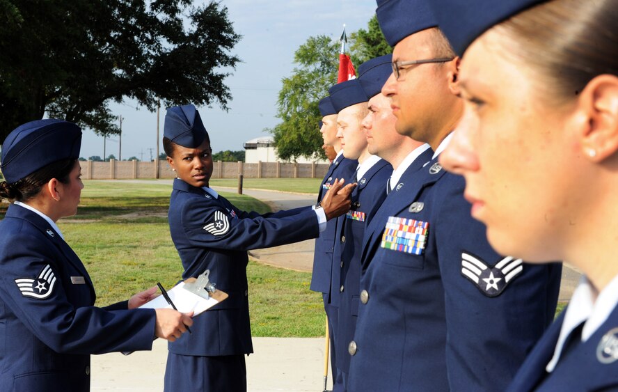 U.S. Air Force Tech. Sgt. April Howard, 20th Force Support Squadron Airman Leadership School instructor, point out discrepancies during the Airmen?s first service dress inspection at Shaw Air Force Base, S.C. July 10, 2011. ALS is a five-week course designed to turn airmen into supervisors and focuses on leadership and leadership duties. (U.S. Air Force photo/Airman 1st Class Tabatha L. Duarte)(Released)