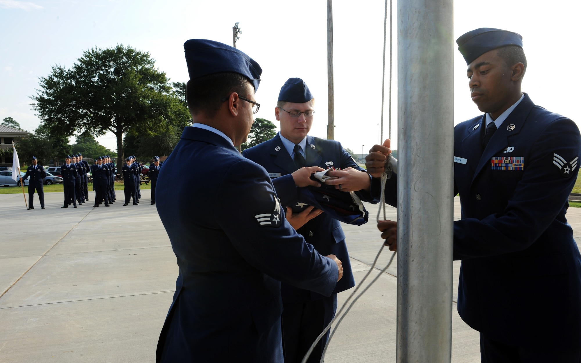 Airman Leadership School students raise the flag during reveille at Shaw Air Force Base, S.C. July 10, 2011. ALS is a five-week course designed to turn airmen into supervisors and focuses on leadership and leadership duties. (U.S. Air Force photo/Airman 1st Class Tabatha L. Duarte)(Released)