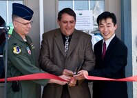 Col. Mark Weatherington, 28th Bomb Wing commander, Al Dial, mayor of Box Elder, S.D., and Derek Veerkamp, Hunt Corporation vice president, cut the ribbon to Centennial Estates on Ellsworth Air Force Base, S.D., Aug. 5, 2011. All Centennial residents were invited to the ribbon cutting ceremony to mark the company’s taking responsibility of more than 800 housing units. The event also included a neighborhood party with displays from several military and civilian organizations and inflatable activities for children. (U.S. Air Force photo/Airman Alystria Maurer/Released)