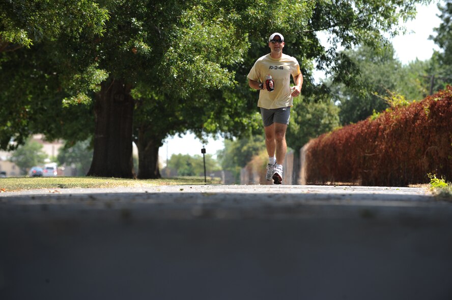 Maj. Bryon Gleisner, Air Force Global Strike Command, runs down a trail on Barksdale Air Force Base, La., Aug. 10. Recent temperatures on Barksdale have reached up to 107 degrees, so it is important to ensure that you stay hydrated and take frequent breaks in shaded areas.  (U.S. Air Force photo/Airman 1st Class Micaiah Anthony)(RELEASED)