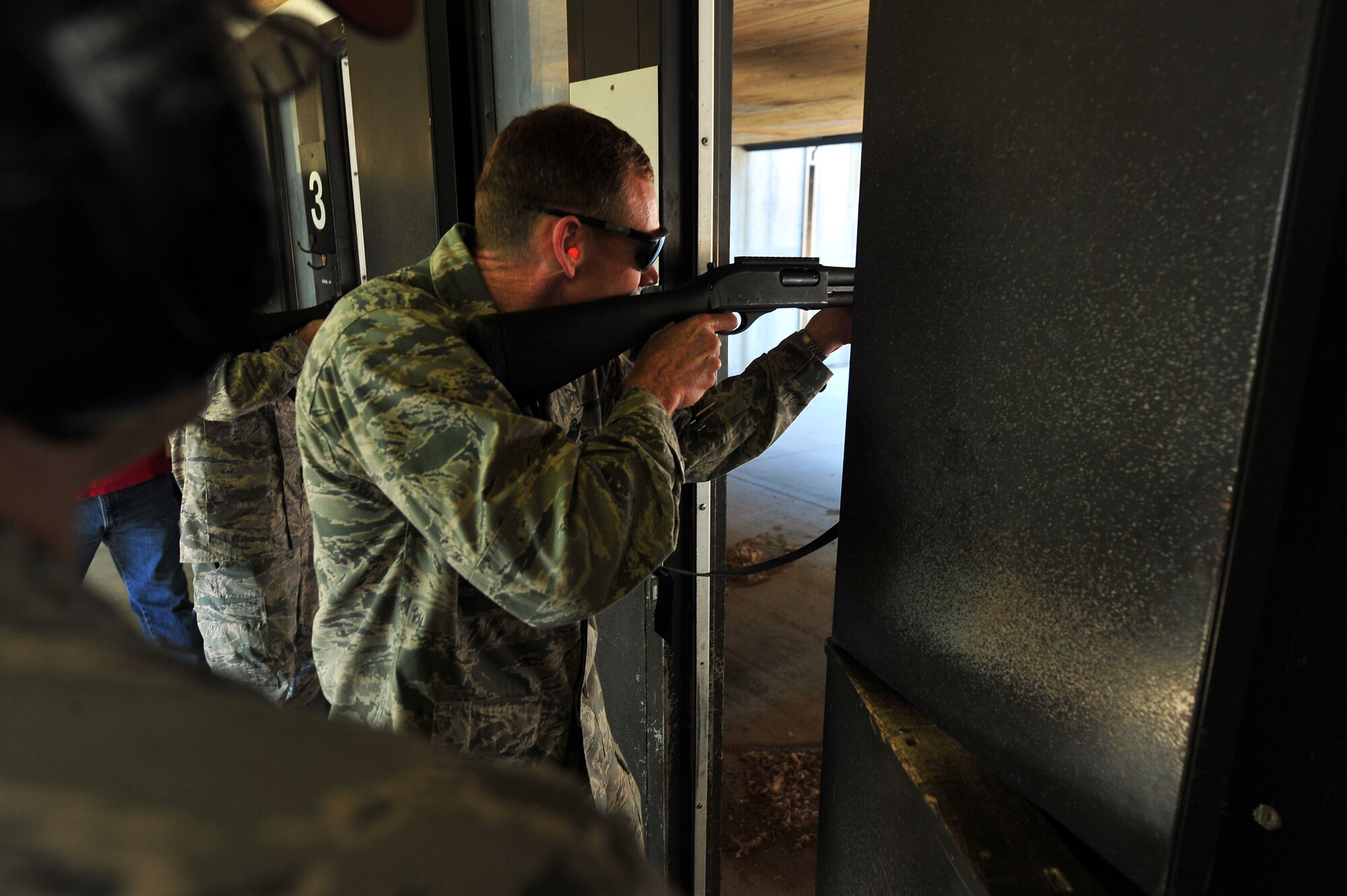 MINOT AIR FORCE BASE, N.D. – Col. James Dawkins, 5th Bomb Wing Commander, fires a shotgun at the combat arms training and maintenance firing range during a tour of the 5th Security Forces Squadron’s base operations here Aug. 9. The 5th SFS demonstrate the daily accomplishment of their primary mission to provide 24-hour law enforcement and security services for the 5th Bomb Wing and all tenant units assigned to Minot AFB. (U.S. Air Force/ Senior Airman Jesse Lopez)