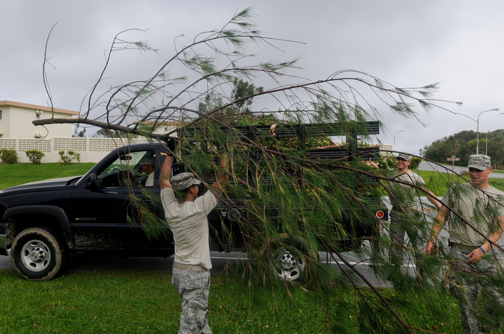 Members from the 18th Civil Engineer Squadron clean up debris from Typhoon Muifa Aug. 8. The tropical storm, which first hit Okinawa Aug. 4 and lasted through the morning of Aug. 6, caused damages to homes, vehicles and other property adding up to around $1 million. (U.S. Air Force photo/Airman 1st Class Maeson L. Elleman)
