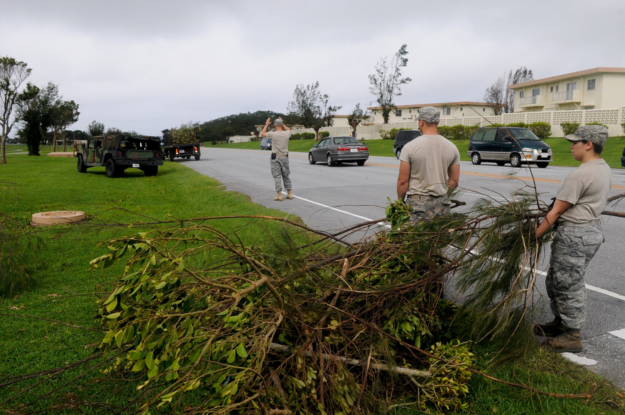 Members from the 18th Civil Engineer Squadron clean up debris from Typhoon Muifa Aug. 8. The typhoon hit Okinawa Aug. 4 and lasted through the morning of Aug. 6, causing roughly $1 million in personal and government property damage on Kadena. (U.S. Air Force photo/Airman 1st Class Maeson L. Elleman)