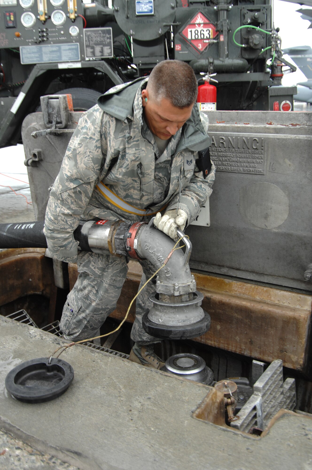 Staff Sgt. Timothy Vesich, a fuels specialist for the 127th Logistics Readiness Squadron, connects the hose of a fuel truck to the underground hydrant system at Joint Base Elmendorf/Ft. Richardson, Alaska, in order to transfer fuel to a C-17 of the 3rd Airlift Wing on the ramp.  Approximately 40 Airmen from the 127th LRS from Selfridge Air National Guard Base, Mich., spent their two weeks of annual training integrated with the active duty and guard personnel of Joint Base Elmendorf/Ft. Richardson, where they accomplished core task training, and shared knowledge and skills with their counterparts.  (USAF Photo by SSgt. Rachel Barton)