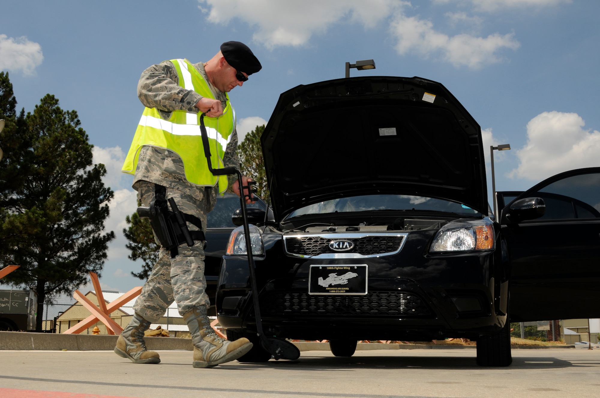 Senior Airman James Hayes of the 188th Security Forces Squadron uses a mirror to conduct a routine vehicle check for foreign objects during an Air Combat Command Phase I Operational Readiness Inspection July 16. (U.S. Air Force photo by Amn. Hannah Landeros/188th Fighter Wing Public Affairs)