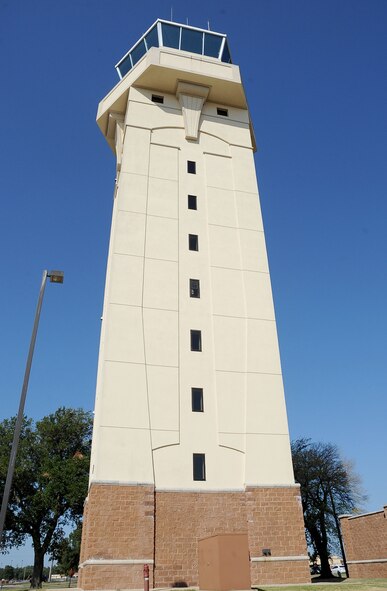Standing at approximately 10 stories tall, the base air traffic control tower houses several offices and the air traffic control crew that run the aircraft activity on the flight line. The tower has at least four air traffic controllers  on shift at all times, including the local controller, flight data, ground controller and the watch supervisor. More than 30 operations are run over a 24-hour period and is manned seven days a week. (U.S. Air Force photo/Senior Airman Amber Ashcraft) (RELEASED)