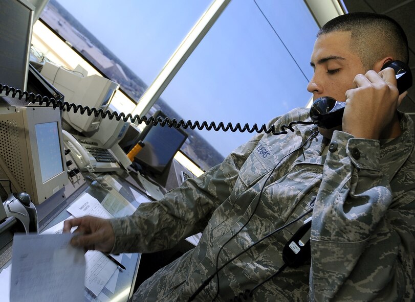Airman 1st Class Carlos Villegas, 2nd Operations Squadron air traffic controller, briefs weather information to incoming aircraft on Barksdale Air Force Base, La., Aug. 9. The tower has at least four air traffic controllers  on shift at all times, including the local controller, flight data, ground controller and the watch supervisor. More than 30 operations are run over a 24-hour period and is manned seven days a week. (U.S. Air Force photo/Senior Airman Amber Ashcraft) (RELEASED)