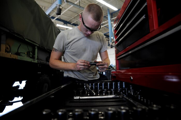 Airman 1st Class Matthew Fincher chooses the appropriate size socket Aug. 9 at the vehicle maintenance shop at Joint Base Charleston - Air Base  Fincher is in training at the shop and is learning to remove the bolts from a wheel hub.  Fincher is from the 628th Logistics Readiness Squadron. (U.S. Air Force photo/ Staff Sgt. Nicole Mickle)  