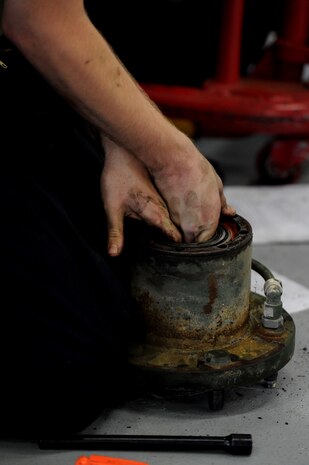 Airman 1st Class Matthew Fincher works on a wheel hub Aug. 9 at the vehicle maintenance shop at Joint Base Charleston - Air Base.  Fincher is from the 628th Logistics Readiness Squadron. (U.S. Air Force photo/ Staff Sgt. Nicole Mickle)