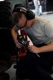 Airman1st Class Matthew Fincher fits a socket onto an air impact wrench at the vehicle maintenance shop at Joint Base Charleston - Air Base Aug. 9. Fincher is from the 628th Logistics Readiness Squadron.  (U.S. Air Force photo/ Staff Sgt. Nicole Mickle)