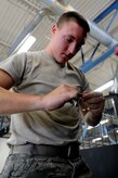 Airman 1st Class Andrew Keller checks the size of a socket as he prepares to repair a leaking radiator hose at Joint Base Charleston - Air Base Aug. 9. Airman Keller is from the 628th Logistics Readiness Squadron.  (U.S. Air Force photo/ Staff Sgt. Nicole Mickle) 
