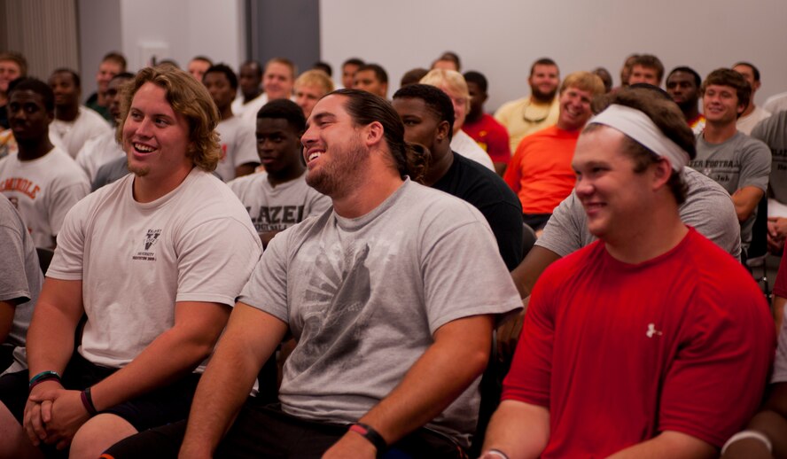 Valdosta State University football players laugh at a joke told by U.S. Air Force Col. Randall Richert, 820th Base Defense Group commander, during a team meeting in Valdosta, Ga., Aug. 7, 2011.  Richert repeated his favorite football quote and said he never lost a football game he just ran out of time. Richert was invited as a guest to speak to the players about their motto for the season “Finish” and to stress the importance of finishing as a team. (U.S. Air Force photo by Andrea Thacker/Released)