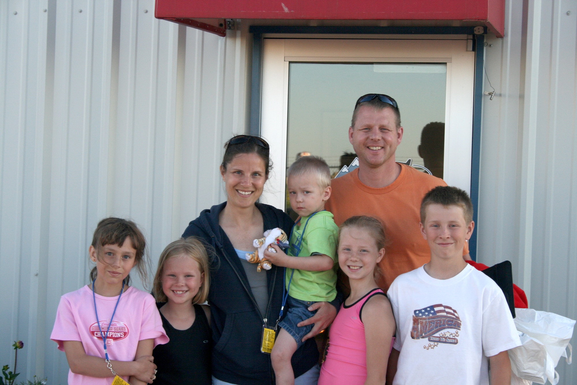 Lt. Col. Michael Kardoes, 40th Helicopter Squadron commander; his wife, Nicole and three children pose with Zibela, 9, and Roberts, 4, after they arrived in Montana July 1. Children pictured from left to right: Zibela, 9; Rebecca, 7; Roberts, 4; Jillian, 10; and Ryan, 12. (Courtesy photo)