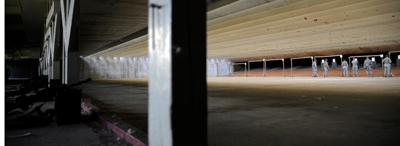 WHITEMAN AIR FORCE BASE, Mo. - Members of the 509th Security Forces Squadron check their practice targets alongside combat arms and maintenance instructors here July 28, 2011 to properly sight-in their weapons. The CATM instructors are trained to read the targets and inform the shooters if they need to adjust their sights, improve on their breathing or work on other firing fundamentals.  (U.S. Air Force photo by Airman 1st Class Cody H. Ramirez)
