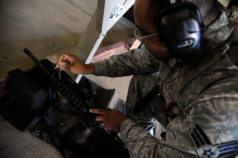 WHITEMAN AIR FORCE BASE, Mo. - Senior Airman Lawrence Saunders, 509th Security Forces Squadron, adjusts the sights on his M4 Carbine here July 28, 2011 during qualification firing. The members are allowed practice rounds to ensure their weapons are firing straight prior to their qualifying test. (U.S. Air Force photo by Airman 1st Class Cody H. Ramirez)