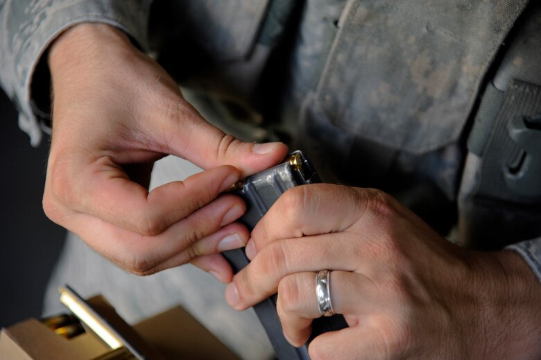 WHITEMAN AIR FORCE BASE, Mo. - A member of the 509th Security Forces Squadron loads a magazine for his M4 Carbine here July 28, 2011 during qualification firing. Airmen must shoot 32 of 50 targets to pass proficiently, but 43 of 50 targets are required for Airmen be considered an expert marksman. (U.S. Air Force photo by Airman 1st Class Cody H. Ramirez)
