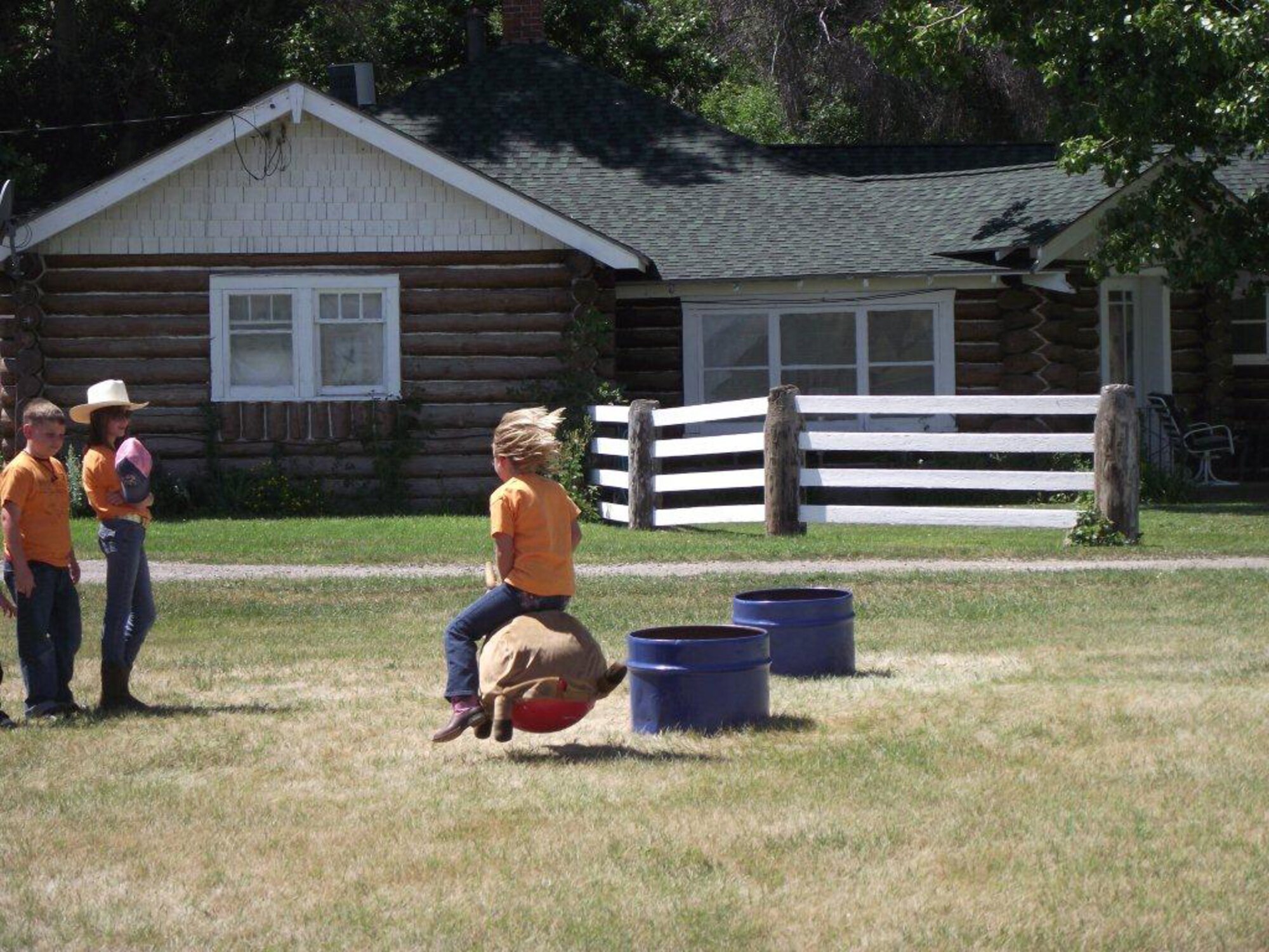 Ashleigh Myers, 9, uses a bouncy ball disguised as a horse to practice barrel racing as Brandon Ergish, 8, and Hannah Rearick, 12, watch to the side.  (Courtesy Photo)