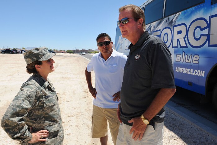 U.S. Air Force Col. Carol C. Yannarella, 99th Air Base Wing vice commander, greets Jim Fassel, coach of the Las Vegas Locomotives football team, and Ruben Herrera, Business Development executive vice president, Aug. 5, 2011, at Nellis Air Force Base, Nev.  The Locos football players, dancers and coaches toured Nellis AFB and spent time at the Nellis Youth Center teaching the children the fundamentals of football, dancing and sportsmanship. (U.S. Air Force photo by Staff Sgt. Taylor Worley/ Released)