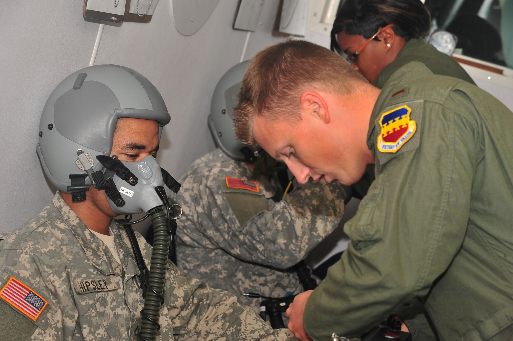 U.S. Air Force 2nd Lt. Stuart Sauls, 20th Aerospace Medicine Squadron physiologist, assists Soldiers and Airmen before the exercise training, Shaw Air Force Base, S.C., Aug. 10, 2011. High altitutde training is a necessity before flying and must be completed to be on flying status. (U.S. Air Force photo by Airman 1st Class Ashley Gardner)(Released)