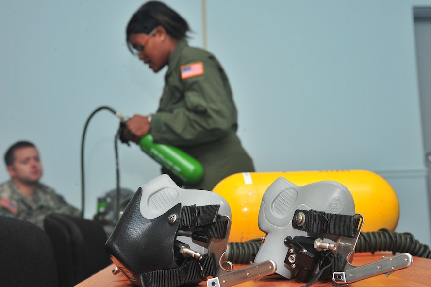 U.S. Air Force Staff Sgt. Whitney Moore, 20th Aerospace Medicine Squadron physiology technician, gives instructions on the gear used in training, Shaw Air Force Base, S.C., Aug. 10, 2011. High altitude training is a necessity before flying and must be completed to be on flying status. (U.S. Air Force photo by Airman 1st Class Ashley Gardner)(Released)