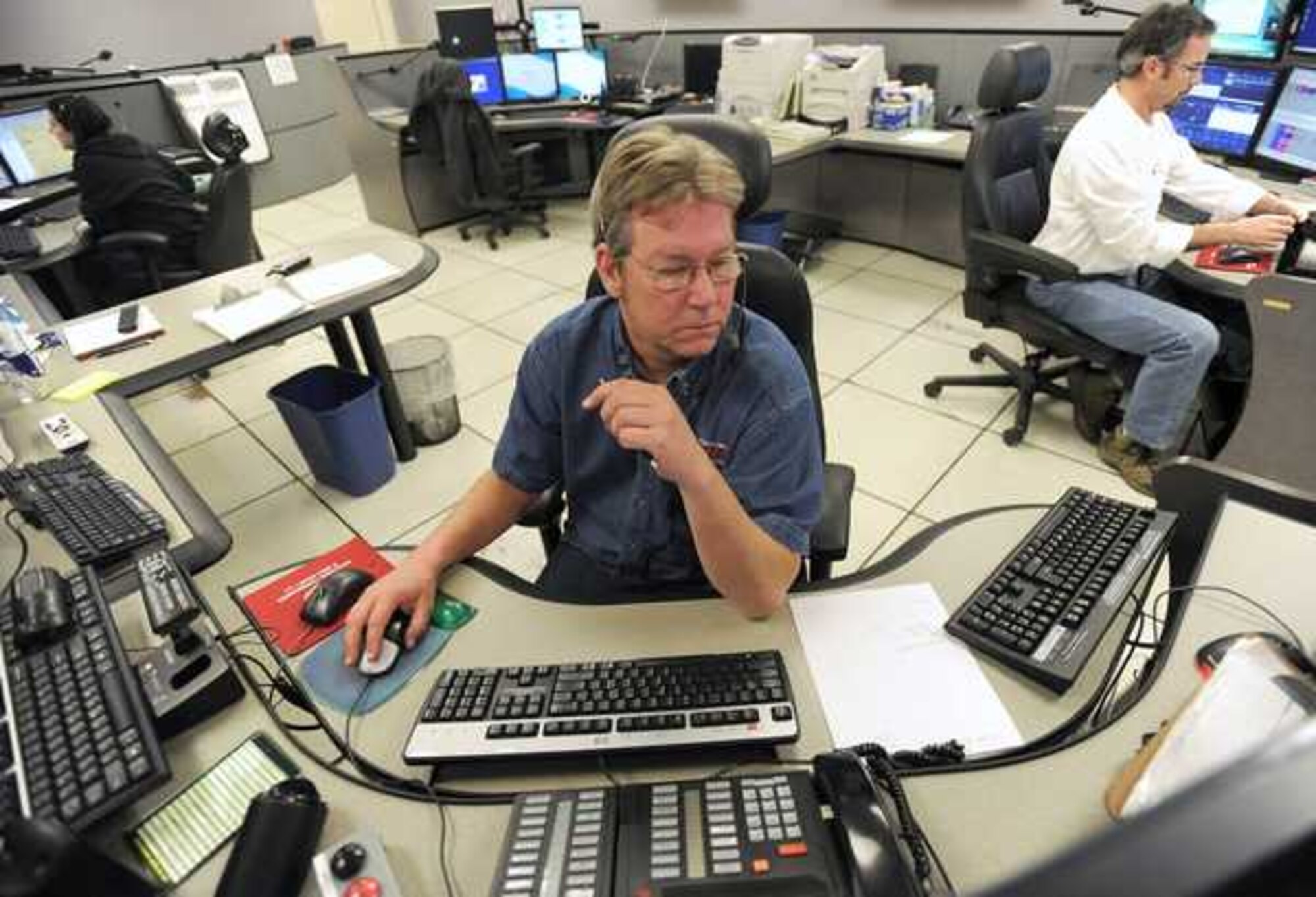 Kevin Sibbitt, Joint Base Emergency Communication Center supervisor, listens to a 911 call during a shift in April 2011 at Joint Base Lewis-McChord, Wash. (U.S. Air Force photo/Ingrid Barrentine)
