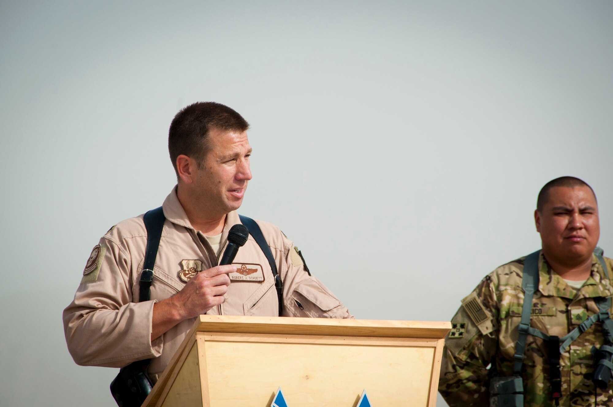 KANDAHAR AIRFIELD, Afghanistan  --  Lt. Col. Robert Schuett speaks to the attendees of the 702nd Expeditionary Airlift Squadron assumption of command here Aug. 9, 2011. The 702nd EAS is a tactical transport squadron, made up of Army and Air Force Guard flying C-27J Spartans to provide support to Forward Operating Bases. The squadron stood up here July 31. (U.S. Air Force photo by Senior Airman Corey Hook/Released)